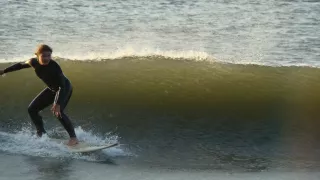 Lynne surfing on a wave